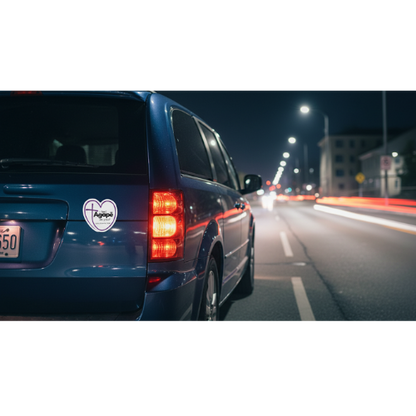 Agapē mission magnet on blue vehicle at night, visible on rear panel